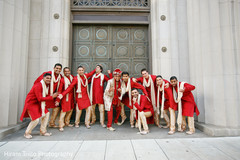 Indian groom and groomsmen in red outfits.