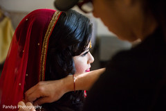 Indian beauty getting help with her bridal dupatta. Indian beauty getting help with her bridal dupatta.