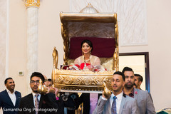 Beautiful indian bride enters the ceremony carried in a golden palanquin. Beautiful indian bride enters the ceremony carried in a golden palanquin.