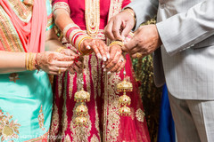 Parents helping the bride to put on her accessories. Parents helping the bride to put on her accessories.