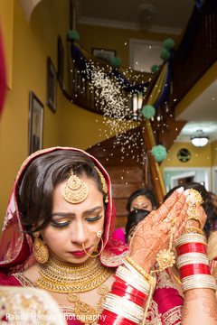 Sikh bride showers herself in rice. Sikh bride showers herself in rice.