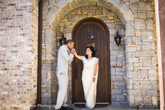 Indian groom kissing bride's hand before wedding ceremony Indian groom kissing bride's hand before wedding ceremony