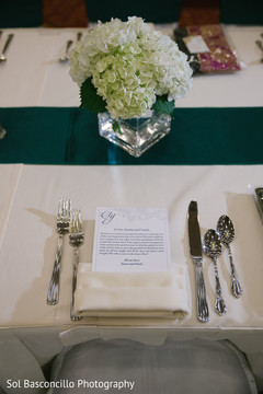 Table with invitation at indian wedding reception indian wedding photography,floral centerpieces,indian wedding planning and design