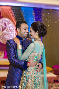 Indian couple hugging at sangeet ceremony Indian couple hugging at sangeet ceremony