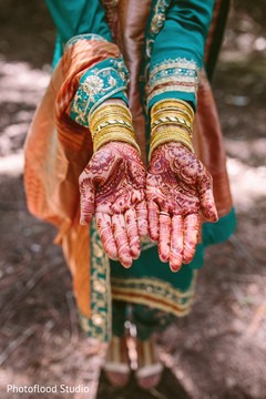 Indian bride showing her mehndi art and bangles before sangeet ceremony pre-wedding ceremony photography,indian wedding mehndi,bride bangles