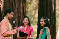 Indian couple reading their vows at sangeet ceremony indian bride hair and makeup,bridal tikka,outdoor photography