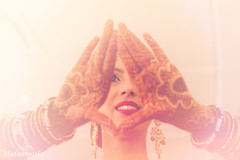 Indian bride showing her makeup, mehndi art and jewelry Indian bride showing her makeup, mehndi art and jewelry