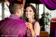 Indian couple smiling at sangeet ceremony Indian couple smiling at sangeet ceremony