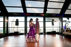 Indian couple dancing at sangeet ceremony Indian couple dancing at sangeet ceremony