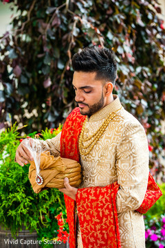 Indian groom ready in his cream and gold sherwani. Indian groom ready in his cream and gold sherwani.