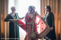 Indian bride getting some extra help with her outfit. Indian bride getting some extra help with her outfit.