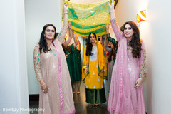 Bride entering her mehndi celebration. indian pre-wedding celebrations,indian wedding guests,pakistani bride