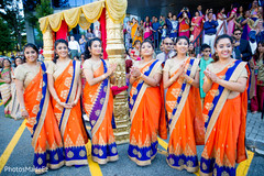 Lovely bridesmaids in royal blue and orange saris. Lovely bridesmaids in royal blue and orange saris.