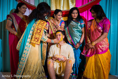 Applying haldi to the groom Applying haldi to the groom