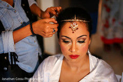 Gorgeous bride preparing her look for her big day. indian bride getting ready,indian bride,indian bridal jewelry