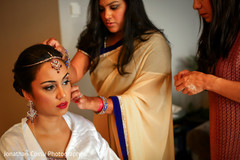 Indian bride getting some help with her jewelry. indian bride getting ready,indian bride,indian bridal jewelry
