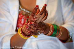 Indian bride puts her wedding bangles on. indian bride getting ready,indian bride,indian bridal jewelry